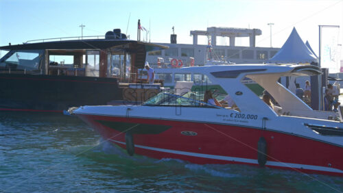Cannes, France – June 22, 2025: People in a boat moving through the Cannes harbour in daylight - Starpik Stock