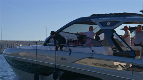 Cannes, France – June 22, 2025: People in a boat moving through the Cannes harbour in daylight - Starpik Stock