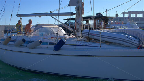 Cannes, France – June 22, 2025: People in a boat moving through the Cannes harbour in daylight - Starpik Stock