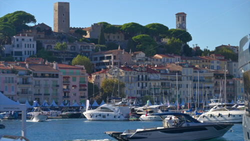 Cannes, France – June 22, 2025: People in a boat moving through the Cannes harbour in daylight - Starpik Stock