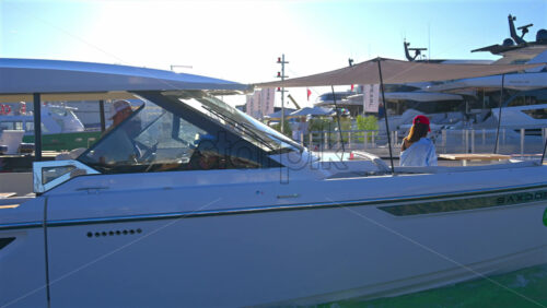 Cannes, France – June 22, 2025: People in a boat moving through the Cannes harbour in daylight - Starpik Stock