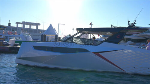Cannes, France – June 22, 2025: People in boats moving through the Cannes harbour in daylight - Starpik Stock