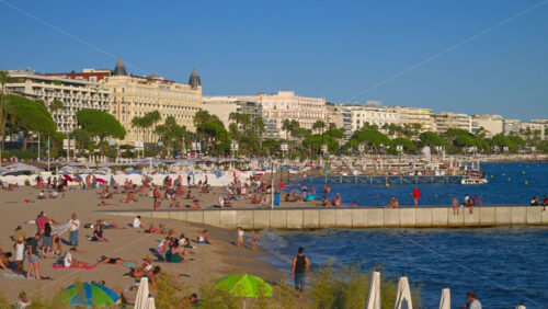 Cannes, France – June 22, 2025: People relaxing and having fun at the beach in daylight - Starpik Stock