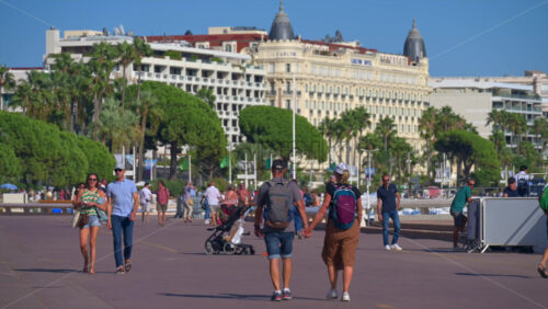 Cannes, France – June 22, 2025: People walking on the streets of the city in daylight - Starpik Stock