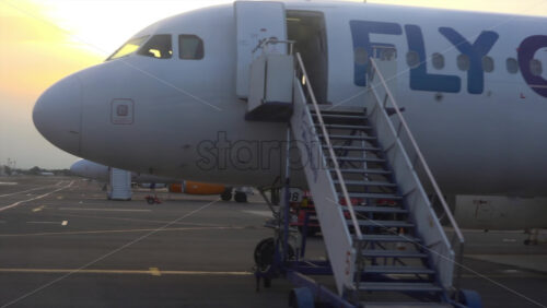 Chisinau, Moldova – July 1, 2025: Passenger aircrafts on the tarmac during a golden sunset at the Chisinau International Airport - Starpik Stock