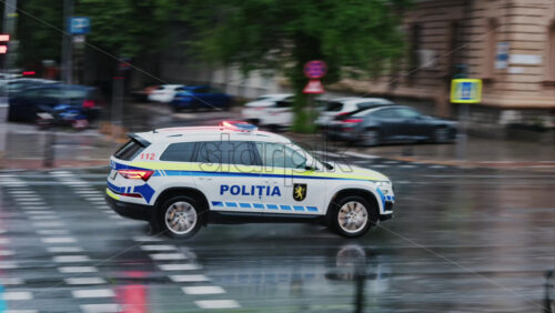 Chisinau, Moldova – June 11, 2025: Police car rushing on the streets of the city center on a rainy day - Starpik Stock