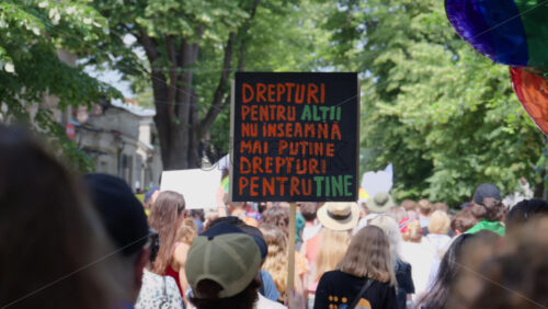 Chisinau, Moldova – June 15, 2025: People marching and holding signs at the Pride Parade in the city center – Translation: “Rights for others do not mean fewer rights for you” - Starpik Stock