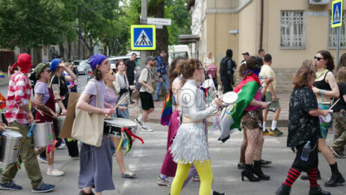 Chisinau, Moldova – June 15, 2025: People marching, holding signs and beating the drums at the Pride Parade in the city center – Translation: “I will love my child no matter who they love” - Starpik Stock