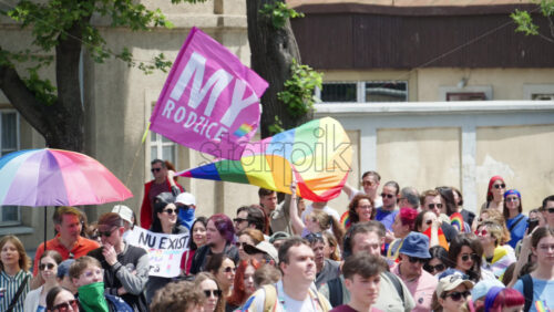 Chisinau, Moldova – June 15, 2025: People marching, holding signs and rainbow umbrellas at the Pride Parade in the city center - Starpik Stock