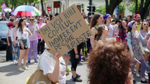 Chisinau, Moldova – June 15, 2025: People marching, holding signs, beating the drums and chanting at the Pride Parade in the city center – Translation: “I will love my child no matter who they love” - Starpik Stock