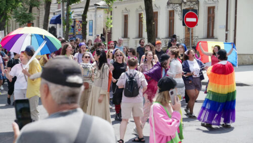 Chisinau, Moldova – June 15, 2025: People marching, holding signs, beating the drums and chanting at the Pride Parade in the city center – Translation: “We love the same” - Starpik Stock