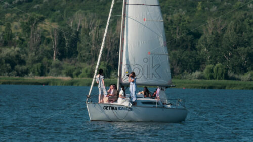 Chisinau, Moldova – June 17, 2025: A group of friends enjoying a relaxing sailing trip and taking pictures on a yacht during a sunny afternoon - Starpik Stock