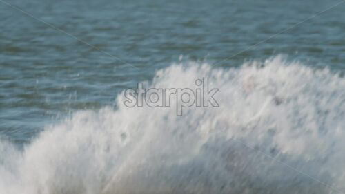 Chisinau, Moldova – June 17, 2025: A man in a black life vest riding a black jet ski at high speed across a calm body of water - Starpik Stock