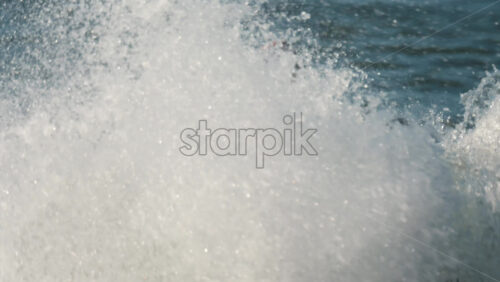 Chisinau, Moldova – June 17, 2025: A man in a black life vest riding a black jet ski at high speed across a calm body of water - Starpik Stock