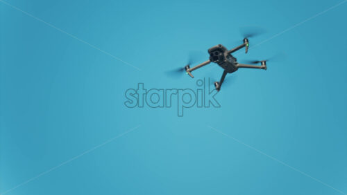 Chisinau, Moldova – June 17, 2025: Low angle view of a drone hovering against a vivid blue sky - Starpik Stock