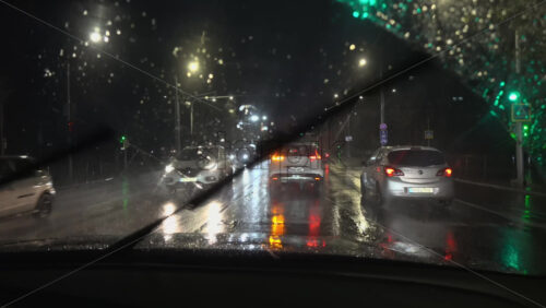Chisinau, Moldova – June 7, 2025: View from the windshield of a moving car on the streets of the city on a rainy evening - Starpik Stock