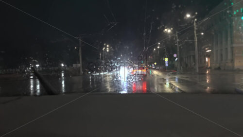 Chisinau, Moldova – June 7, 2025: View from the windshield of a moving car on the streets of the city on a rainy evening - Starpik Stock