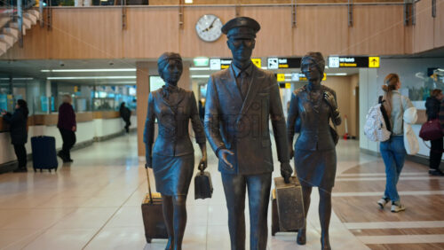 Chisinau, Moldova – March 20, 2025: Pilot and two flight attendants sculpture at the Chisinau International Airport - Starpik Stock