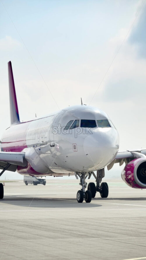 Chisinau, Moldova – March 20, 2025: View of a white WizzAir airplane moving at the Chisinau International Airport. Vertical - Starpik Stock