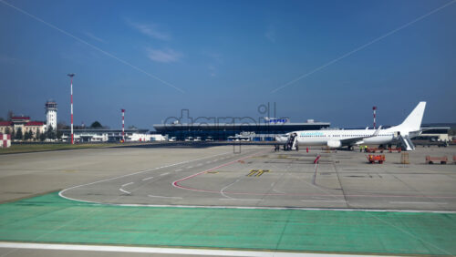Chisinau, Moldova – March 20, 2025: View of a white airplane at the Chisinau International Airport - Starpik Stock