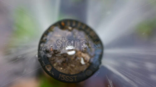 Chisinau, Moldova -August 20, 2025: Close up view of a sprinkler head spraying water with dirt in it - Starpik Stock