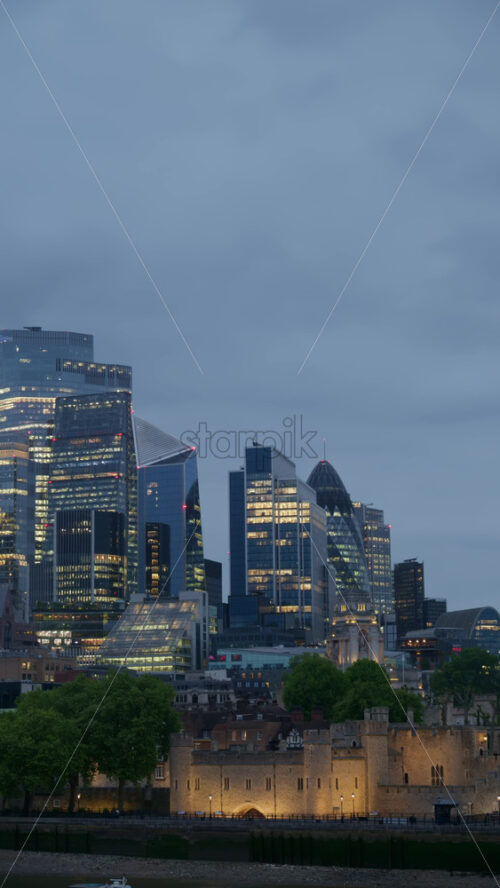 Cityscape view showing the Thames River, modern skyscrapers, including the Walkie Talkie building, and the Tower of London. Vertical - Starpik Stock