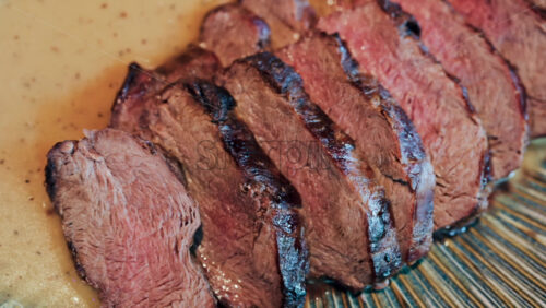 Close up of a London Broil on a colourful plate at a restaurant - Starpik Stock