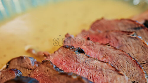 Close up of a London Broil on a colourful plate at a restaurant - Starpik Stock