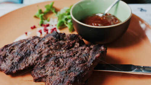 Close up of a Sirloin Steak with Barbecue Sauce and micro-plants on the side - Starpik Stock