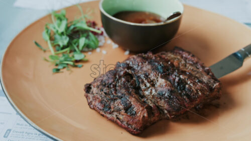 Close up of a Sirloin Steak with Barbecue Sauce and micro-plants on the side - Starpik Stock