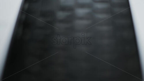 Close up of a black keyboard on a laptop with the light reflecting on it - Starpik Stock