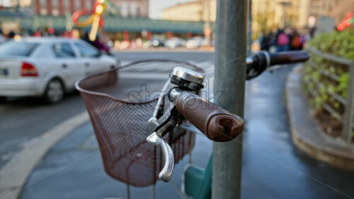 Close up of a brown and green bike parked on the street with a blurred background - Starpik Stock
