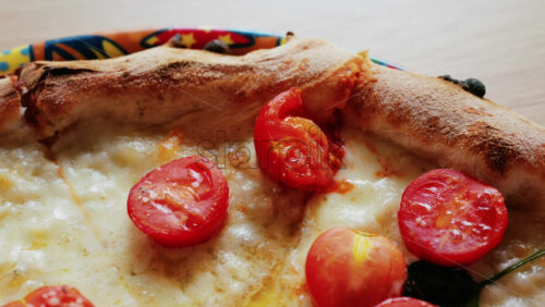 Close up of a classic margherita pizza with cherry tomatoes and basil - Starpik Stock