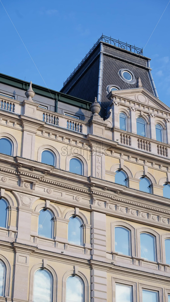 Close-up of a classical historic building facade featuring arched windows, ornamental details in London, England. Vertical - Starpik Stock