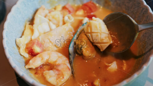 Close up of a creamy seafood stew with mussels, squid, and shrimp - Starpik Stock