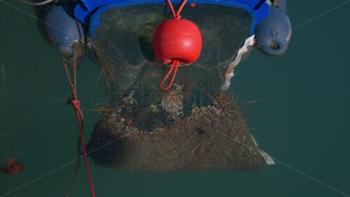 Close up of a floating marine debris collection device in the water - Starpik Stock