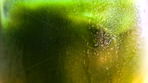 Close up of a glass of an iced orange juice matcha on a table at a cafe - Starpik Stock