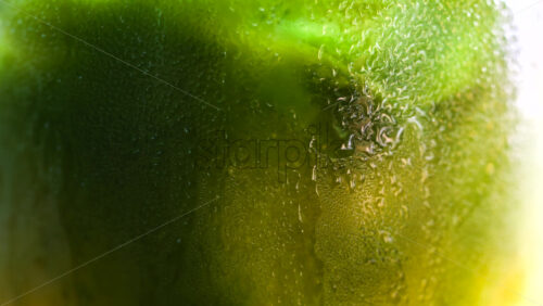 Close up of a glass of an iced orange juice matcha on a table at a cafe - Starpik Stock