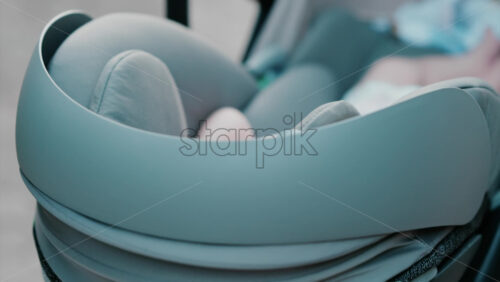 Close up of a mother pushing a stroller with a baby inside - Starpik Stock