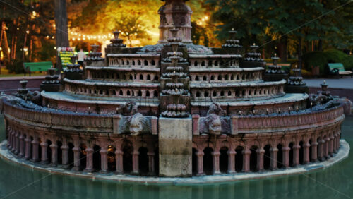 Close up of a water fountain in the Stephen the Great Central Park in Chisinau, Moldova with golden lights in the background - Starpik Stock