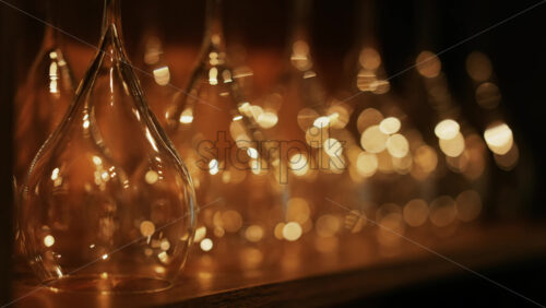 Close up of empty glasses turned upside down on a shelf - Starpik Stock