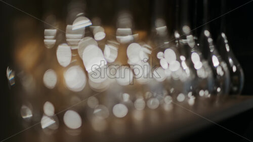 Close up of empty glasses turned upside down on a shelf - Starpik Stock