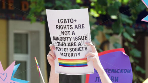 Close up of hands holding signs at the Pride March in Chisinau, Moldova – Translation: “It is impossible to be for freedom and against people” - Starpik Stock