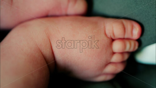 Close up of newborn baby toes showing soft skin and tiny nails - Starpik Stock