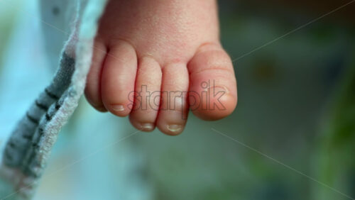 Close up of newborn baby toes showing soft skin and tiny nails - Starpik Stock