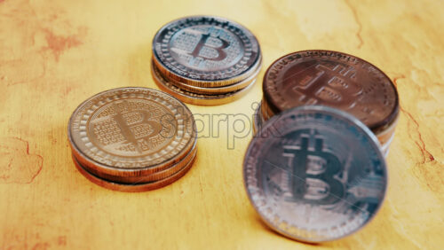 Close up of shiny physical Bitcoin coins stacked on a table - Starpik Stock