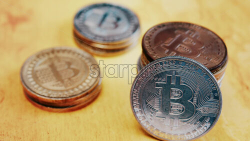 Close up of shiny physical Bitcoin coins stacked on a table - Starpik Stock