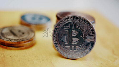 Close up of shiny physical Bitcoin coins stacked on a table - Starpik Stock