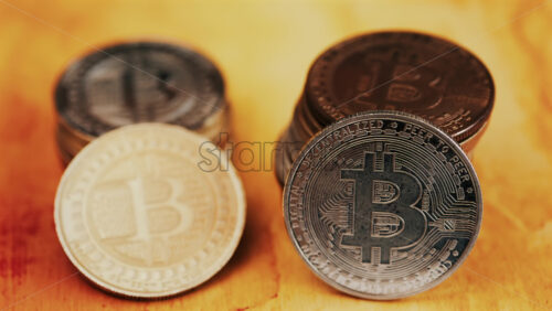 Close up of shiny physical Bitcoin coins stacked on a table - Starpik Stock