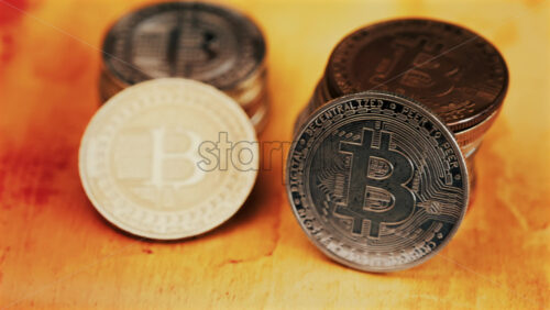 Close up of shiny physical Bitcoin coins stacked on a table - Starpik Stock